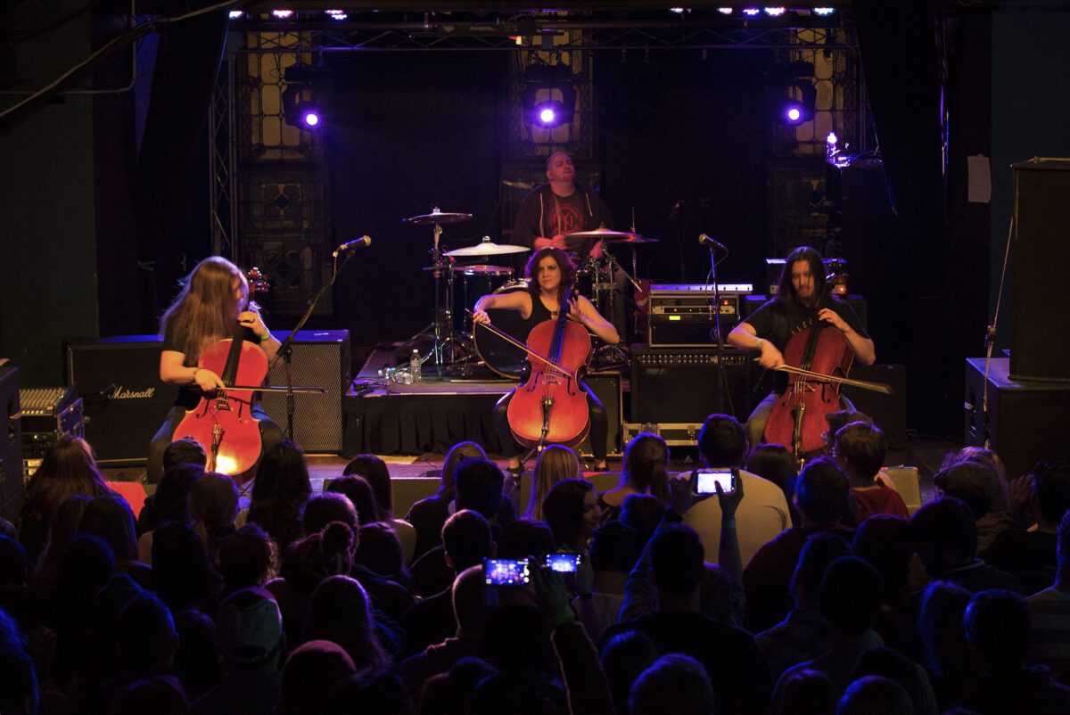 A group of people playing instruments on stage.