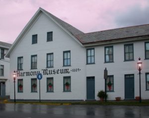 A white building with a blue sign on the front.