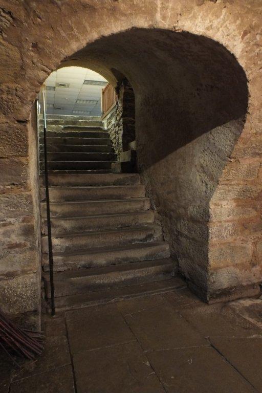 A stone staircase with an arch leading to the top.