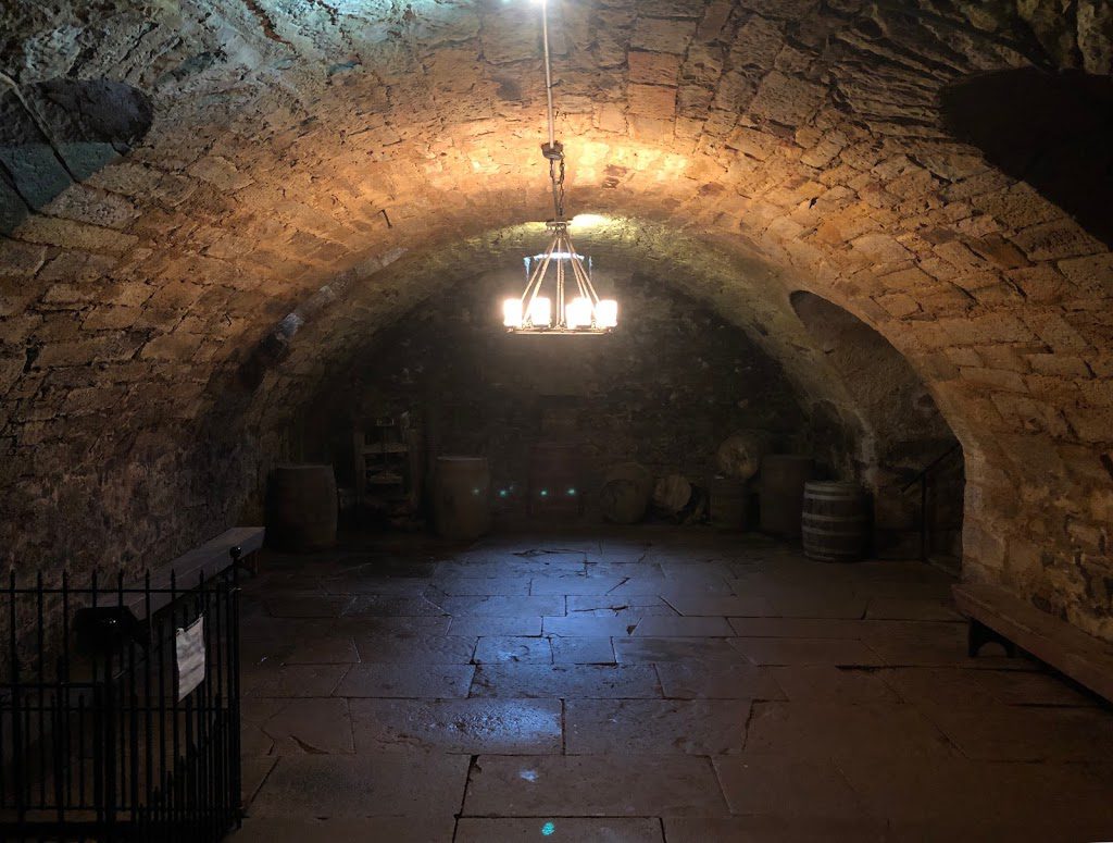 A large stone room with a vaulted ceiling.