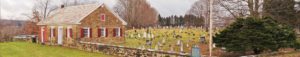 A cemetery with many tombstones in the grass.