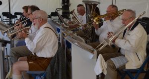 A group of men playing musical instruments in front of a crowd.